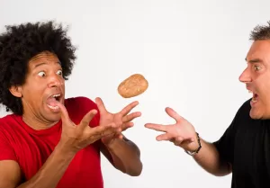 Two people juggling a hot potato